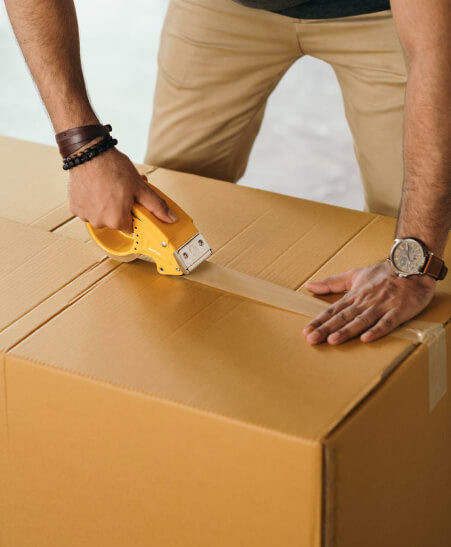 Facility manager packs boxes with out of adoption and surplus textbooks