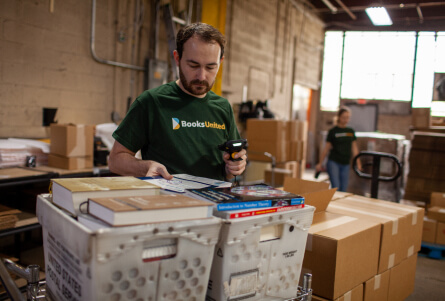 College textbook sourced and picked by warehouse manager ready to get shipped to bookstore